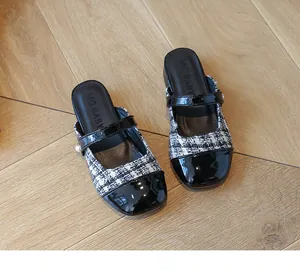 Detailed top view of kids tweed Mary Jane slippers with patent leather and pearl accent