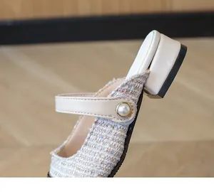 Close-up of girls' tweed Mary Jane sandals featuring pearl strap and low square heels