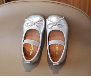 Top view of shiny silver toddler flats with bow detail and elastic strap
