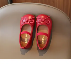 Top view of red leather girls' flat shoes featuring a bow detail and elastic strap