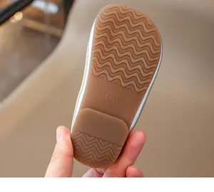 Close-up of non-slip rubber sole with wavy texture and size 23 mark on girls' shoes