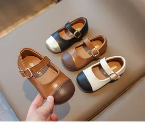 Detailed view of children's Mary Jane leather shoes with adjustable metal buckles