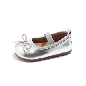 Silver girls Mary Jane flats with bow detail and elastic strap on a white background