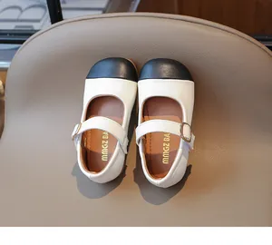 Detailed top view of girls' Mary Jane shoes with black round toe and white body leather
