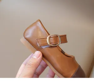 Detail of kids brown Mary Jane shoes with contrast toe and soft rubber sole
