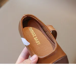 Detailed close-up of brown Mary Jane leather shoe for girls with secure velcro strap