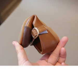 Macro detail showing the high flexibility of the soft brown baby shoe sole and leather upper