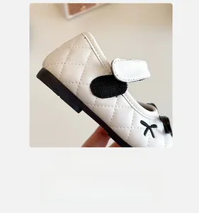 Detail view of white quilted leather Mary Jane shoes with convenient Velcro strap closure