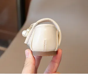 Detail of soft cream Mary Jane shoe with pearl pendant and durable rubber sole