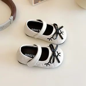 Quilted beige girls princess shoes with black bow and velcro strap for toddlers