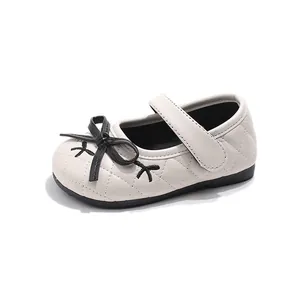 Girls ivory quilted Mary Jane shoes with black bow and velcro strap for comfort
