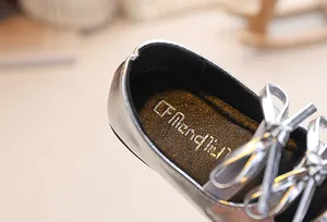 Dettaglio scarpe argento da bambina con fiocco e soletta interna antiscivolo di marca