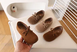 Vue détaillée de chaussures en daim pour filles avec nœud en couleurs automnales terreuses