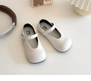 Detail of white girls' Mary Jane shoes with Velcro strap and comfortable soft leather