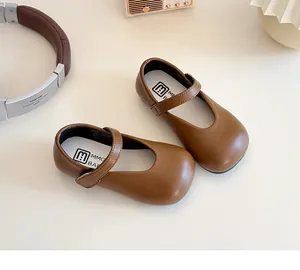 Detailed top view of brown matte leather Mary Jane shoes for girls with velcro strap
