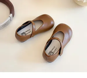 Top view of brown matte leather Mary Jane shoes for girls with velcro strap and logo