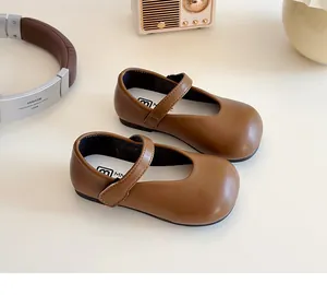 Classic brown leather Mary Jane shoes for children displayed with vintage radio and headphones