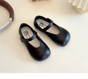 Close-up of black matte Mary Jane leather shoes with velcro strap and round toe design