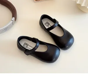 Detail view of black Mary Jane shoes for girls with easy velcro strap and matte finish