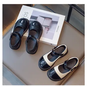 Close-up of girls' Mary Jane shoes in solid black and two-tone spectator color design