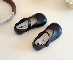 Top view of black matte leather girls' Mary Jane shoes with Velcro straps and soft insoles