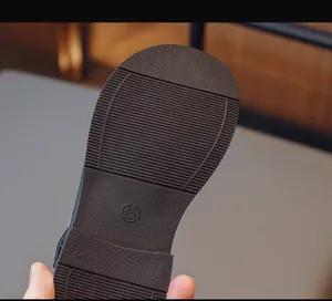 Close-up of non-slip rubber sole for Mary Jane shoes with size 28 and pattern detail