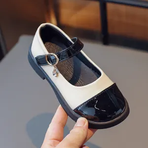 Classic black and white Mary Jane shoes for girls with shiny patent leather and heart charm