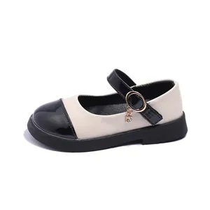 Classic two-tone Mary Jane shoes for girls with black patent leather toe and rhinestone charm