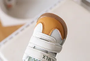Detail view of toddler shoes featuring breathable mesh and reinforced rubber toe cap