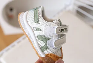 Detail of breathable mesh upper and dual hook-and-loop straps on baby walking shoes