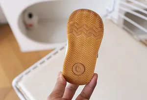 Detailed view of the anti-slip rubber sole with wave pattern and size 18 marking