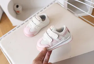 Detail of pink mesh baby walking shoes featuring breathable fabric and dual velcro straps