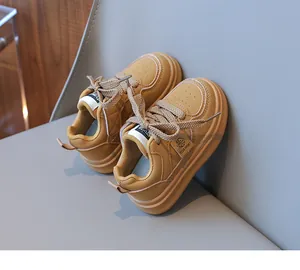 Detail view of mustard yellow kids sneakers featuring non-slip thick soles and woven laces