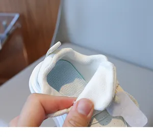 Detail view of breathable mesh lining and soft striped insole for kids white sneakers