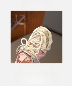 Detailed macro view of breathable mesh upper and pink leather accents on girls sneaker
