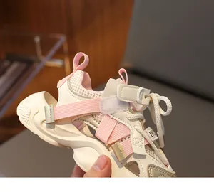 Detailed close-up of kids breathable mesh sports sandals with pink straps and gold accents