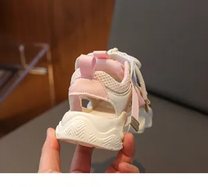 Detail of pink and white kids' sports sandals showing mesh texture and thick soles