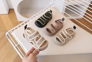 Detail of closed-toe toddler sandals in green, beige, and brown with breathable mesh design