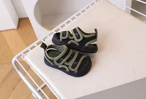 Detail of toddler sandals featuring dual hook-and-loop straps and a protective closed toe