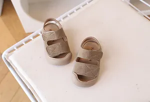 Detail of khaki toddler sandals with double hook-and-loop straps and anti-collision rubber toe