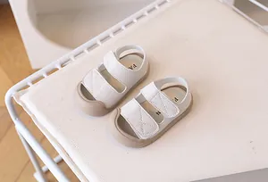 Detail of baby closed-toe sandals with double hook-and-loop straps and cross stitching