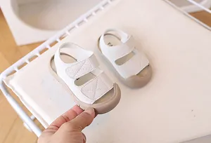 Detail of baby summer sandals showing closed-toe protection and double velcro straps