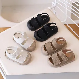 Minimalist anti-collision baby sandals with soft rubber soles in black, white, and khaki