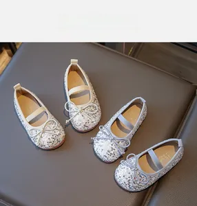 Close-up of girls ballet flats featuring sparkling sequins and cute bow tie details