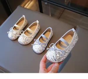 Top view of glitter Mary Jane flat shoes with bow detail and elastic strap for kids
