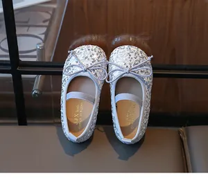 Detail of silver sequin ballet flats for girls with bow decor and elastic strap