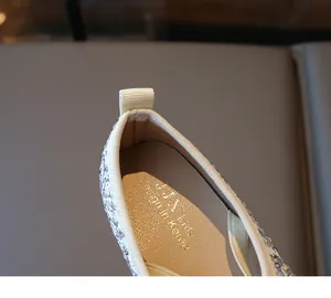 Detail of silver sequin ballet flats with beige leather lining and heel pull tab