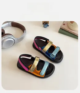 Detailed view of colorful kids sandals with shiny metallic straps and adjustable velcro straps