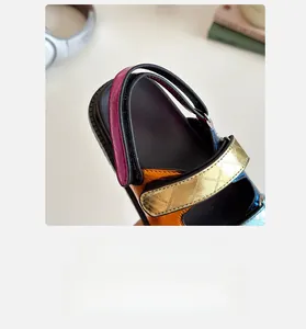 Detail of colorful children's sandals showing quilted gold straps and textured footbeds