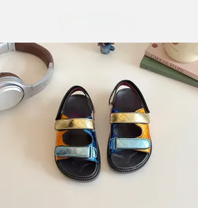 Detail of kids sandals with tri-color metallic leather straps and velcro closure